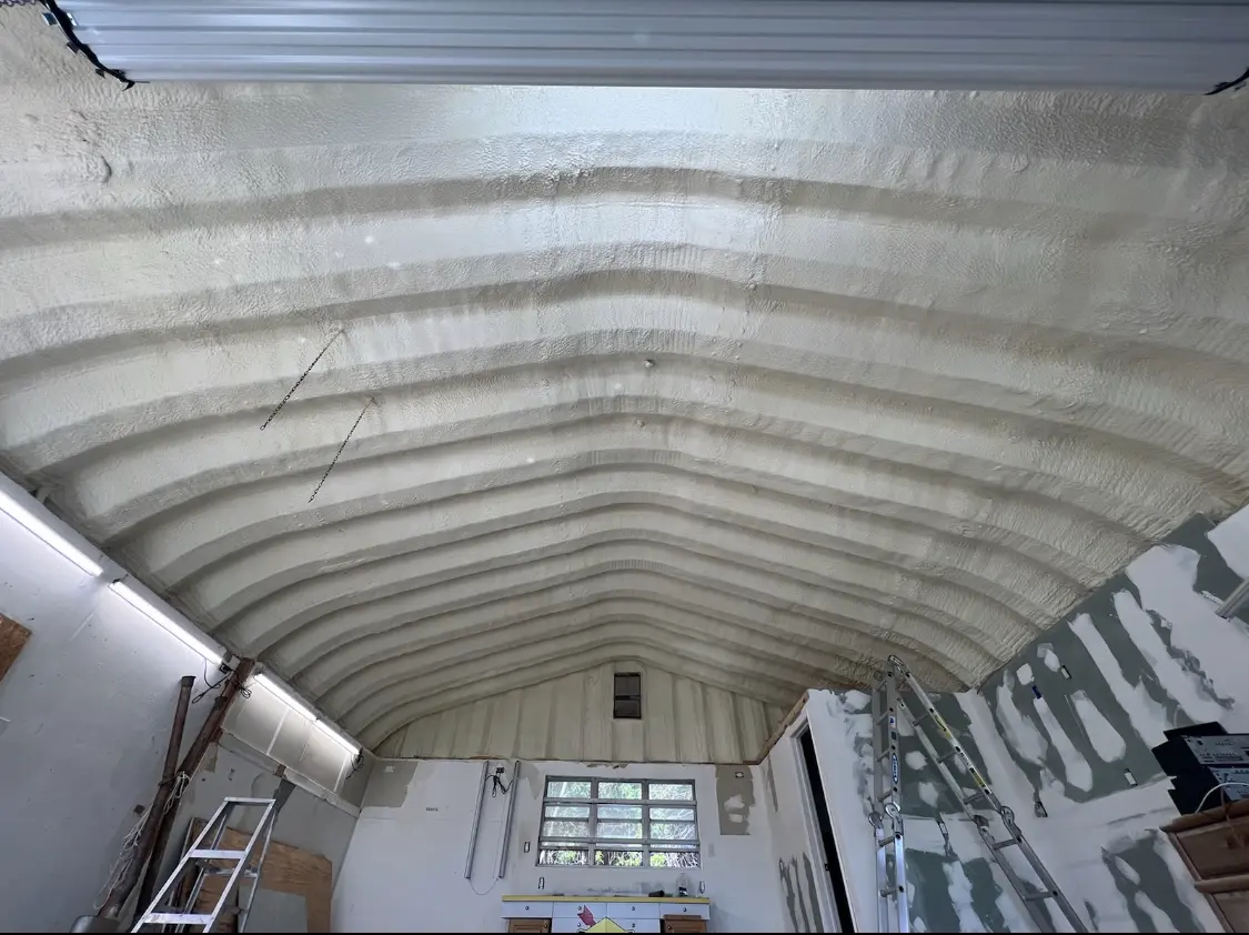 Spray polyurethane foam applied to the underside of a metal roof deck in New Hartford